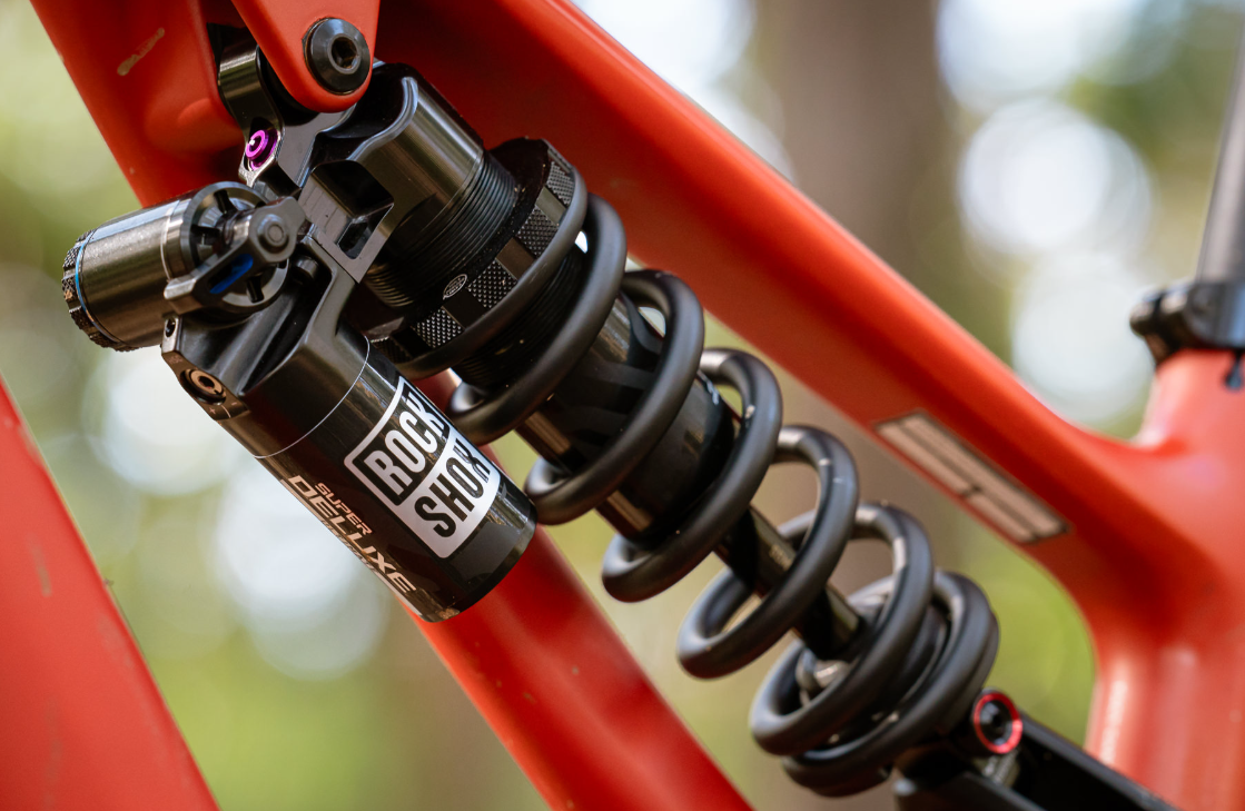 Close-up of a bicycle shock absorber with a blurred natural background