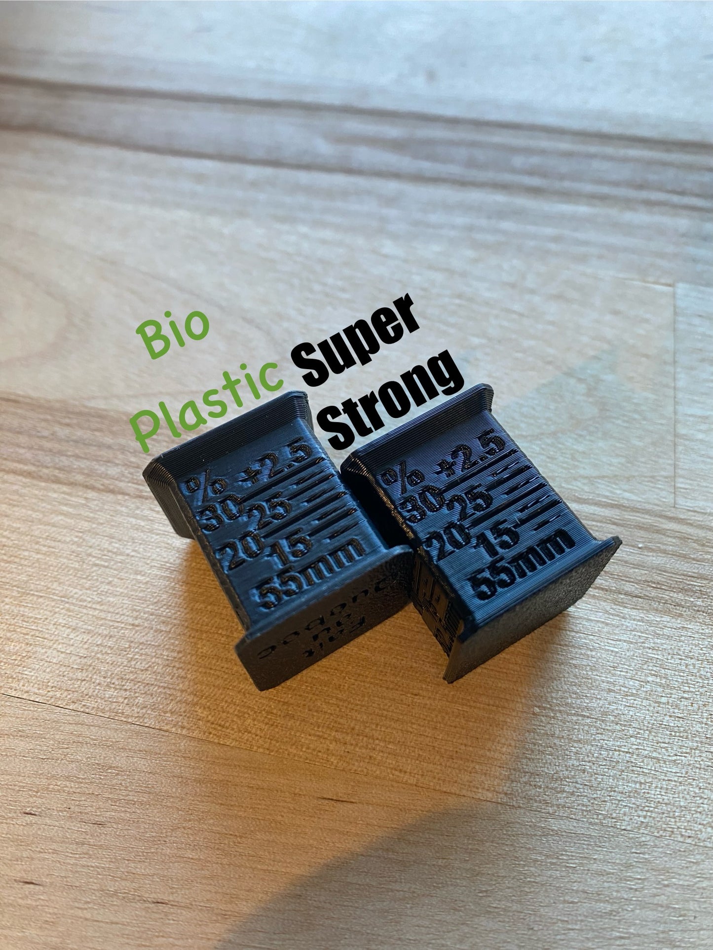 Two SAG Tools on a wooden surfacewith one bio-plastic.
