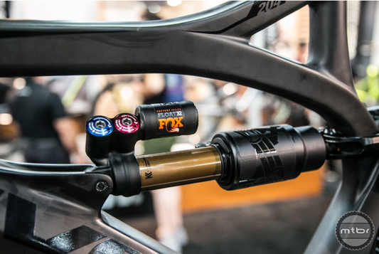 Close-up of a bicycle suspension fork with Fox and MTB branding.