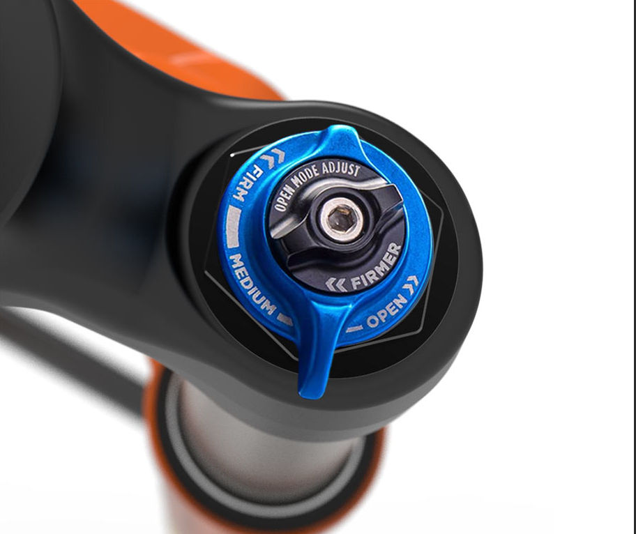 Close-up of a bike suspension fork with a blue adjustment dial on a white background