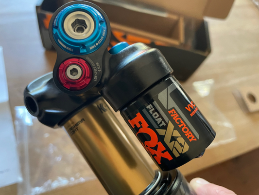 Close-up of a Fox suspension fork with 'Factory' branding on a blurred background